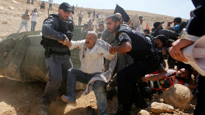 Israeli forces detain a Palestinian man as they protest against Israel's plan to demolish the Palestinian Bedouin village of Khan al-Ahmar, in the West Bank September 14, 2018. Credit: Mussa Qawasma/Reuters