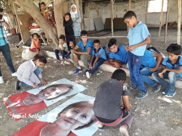 Children in Khan al-Ahmar writing on posters of German Chancellor Angela Merkel on Tuesday, Oct. 2 (Photo Courtesy of Jamal Saifan