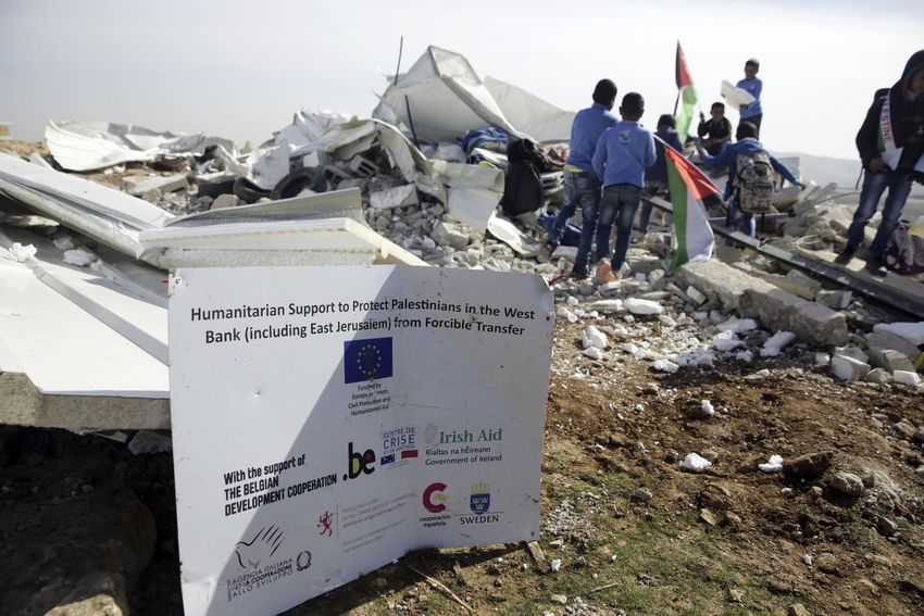 FILE- Bedouin children stand on the rubble of classrooms destroyed by the Israeli army in the village of Abu Nuwar, West Bank, Feb. 4, 2018. Israel said the EU-funded structure was built illegally without proper permits and was in a precarious condition.