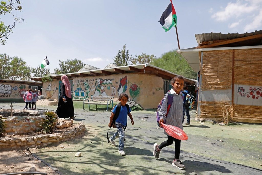Palestinian Bedouin students walk in the courtyard of their primary school in the village of Khan al-Ahmar in the Israeli-occupied West Bank on September 6, 2018. Photo AFP