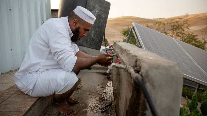 An imam in the Bedouin village of Khan al-Ahmar prepares for prayers, May 3, 2020.Credit: Emil Salman