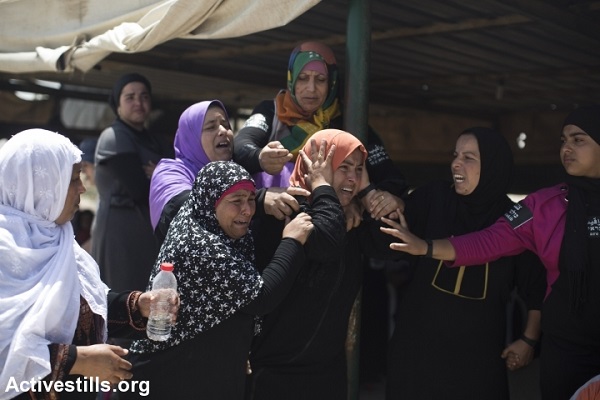 Bedouin women cry as they watch their house being destroyed during the demolition of the unrecognized Bedouin village of Al Arakib in the Negev desert. Israeli authorities have demolished the village over 70 times since 2010, June 12, 2014. (Oren Ziv/Activestills)